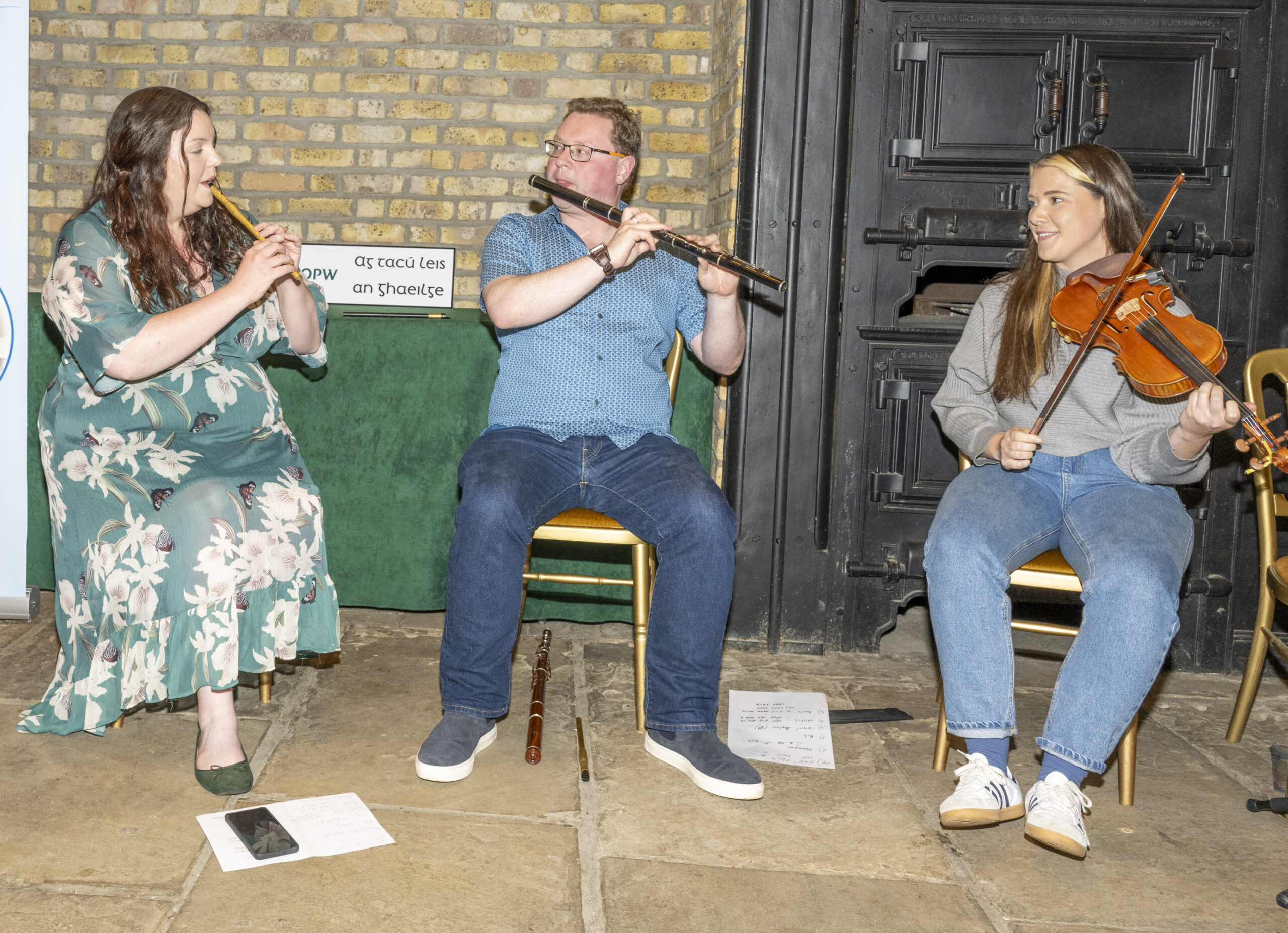 Three musicians playing violin, flute and fiddle